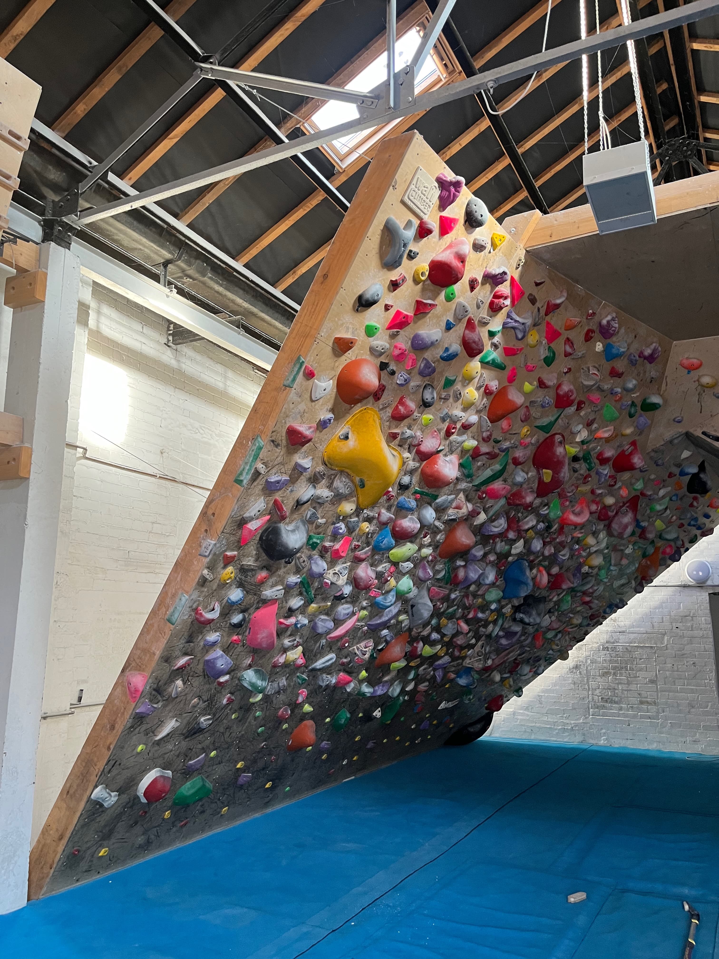 Indoor board session on a steep spray wall in Sheffield.